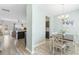Open-concept dining area with luxury vinyl plank flooring that connects to the kitchen and living room at 464 Fox Sparrow Ct, Summerville, SC 29486