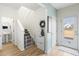 Welcoming entryway with stairs, neutral decor, and access to the half bathroom and backyard at 464 Fox Sparrow Ct, Summerville, SC 29486