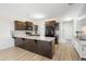 Bright kitchen with dark wood cabinets, stainless appliances, large island with white countertop, and open layout at 464 Fox Sparrow Ct, Summerville, SC 29486