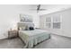 Bright primary bedroom featuring a ceiling fan, two windows, and neutral decor and carpet at 464 Fox Sparrow Ct, Summerville, SC 29486