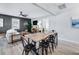 Open-concept dining area with modern black chairs, a wooden table, and seamless flow to the living room at 5034 Pittman St, North Charleston, SC 29405