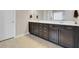 Bathroom showcasing a dark vanity with double sinks, neutral countertops, and tile flooring at 518 Mountain Laurel Cir, Goose Creek, SC 29445