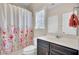Cozy bathroom with floral shower curtain, vanity, and storage at 518 Mountain Laurel Cir, Goose Creek, SC 29445