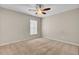 Bright bedroom featuring carpeted flooring, a ceiling fan, and a window at 518 Mountain Laurel Cir, Goose Creek, SC 29445