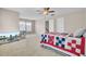 Bedroom features carpet, ceiling fan, and bed with quilt, with stairway entry and a television at 518 Mountain Laurel Cir, Goose Creek, SC 29445