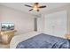 Bedroom features carpet, a ceiling fan, closet doors, and a bed with a blue quilt and a white throw blanket at 518 Mountain Laurel Cir, Goose Creek, SC 29445
