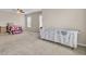 Spacious bedroom with carpet, a bed with a quilt, ceiling fan, and large table with white cloth at 518 Mountain Laurel Cir, Goose Creek, SC 29445