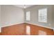 Bright bedroom with hardwood floors and two windows providing natural light at 518 Mountain Laurel Cir, Goose Creek, SC 29445