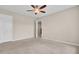 Neutral bedroom with carpeted flooring, a ceiling fan, closet, and access to other rooms at 518 Mountain Laurel Cir, Goose Creek, SC 29445