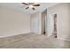 Spacious carpeted bedroom with ceiling fan and double doors leading to bathroom at 518 Mountain Laurel Cir, Goose Creek, SC 29445