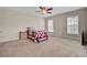 Bedroom features a ceiling fan, carpet, two windows, a bed with a quilt, and a side table at 518 Mountain Laurel Cir, Goose Creek, SC 29445