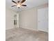 Bedroom featuring carpeted flooring, ceiling fan, closet, and access to other rooms at 518 Mountain Laurel Cir, Goose Creek, SC 29445