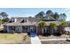 Charming single-story home with a welcoming front porch, a brick facade, and lush landscaping at 518 Mountain Laurel Cir, Goose Creek, SC 29445