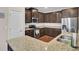 Well-appointed kitchen with granite counters, stainless steel appliances, and dark cabinetry at 518 Mountain Laurel Cir, Goose Creek, SC 29445