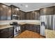 Modern kitchen with stainless steel appliances, dark cabinetry, and granite countertops at 518 Mountain Laurel Cir, Goose Creek, SC 29445