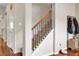 Carpeted staircase featuring wooden handrail and decorative iron spindles at 518 Mountain Laurel Cir, Goose Creek, SC 29445