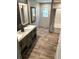 Well-lit bathroom features double sinks, modern fixtures, and ample counter space for storage and convenience at 5355 Old Military Rd, Adams Run, SC 29426