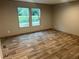 Bedroom features hardwood floors, natural light through the windows, and lots of open floor space at 5355 Old Military Rd, Adams Run, SC 29426