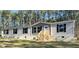 New single-story home featuring gray siding, black shutters, and wooden front steps at 5355 Old Military Rd, Adams Run, SC 29426