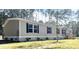 Charming single-story home featuring gray siding, black shutters, and manicured landscaping at 5355 Old Military Rd, Adams Run, SC 29426