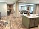 Open concept kitchen and dining area with stainless steel appliances, island with seating, and lots of natural light at 5355 Old Military Rd, Adams Run, SC 29426