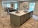 Kitchen island showcases granite countertops, modern fixtures, and views of the adjacent dining area at 5355 Old Military Rd, Adams Run, SC 29426