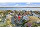 An aerial shot displays a vibrant neighborhood near the water, marked by a prominent red pin on a charming house at 54 Gibbes St, Charleston, SC 29401