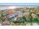Aerial view showcases a charming neighborhood with diverse architecture, set against the backdrop of a glistening waterfront at 54 Gibbes St, Charleston, SC 29401