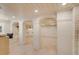 A finished basement featuring arched doorways and tiled flooring, bathed in light from recessed lighting and a window at 54 Gibbes St, Charleston, SC 29401