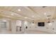 Finished basement space with white wood beams, recessed lighting, and tile floors at 54 Gibbes St, Charleston, SC 29401