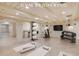 Finished basement featuring exposed beams, tiled flooring, and exercise equipment at 54 Gibbes St, Charleston, SC 29401