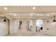 Finished basement with tile flooring, white painted brick and wooden features, and recessed lighting at 54 Gibbes St, Charleston, SC 29401