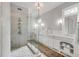 Bright bathroom with marble floors, glass shower, and dual sink vanity at 54 Gibbes St, Charleston, SC 29401