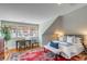 Charming bedroom with a cozy atmosphere, featuring a plush bed, bright windows, and a decorative area rug at 54 Gibbes St, Charleston, SC 29401