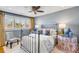 Bright bedroom with a decorative metal bed frame, complemented by colorful decor and sunny windows at 54 Gibbes St, Charleston, SC 29401