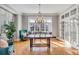 Elegant dining room featuring a large window seat, hardwood floors, and a stylish chandelier for memorable gatherings at 54 Gibbes St, Charleston, SC 29401