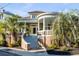 Charming brick home featuring a grand entrance with a curved porch and lush landscaping at 54 Gibbes St, Charleston, SC 29401