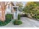 Charming home with a brick facade, lush landscaping, and a driveway leading to the rear of the property at 54 Gibbes St, Charleston, SC 29401