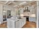 Open kitchen showcasing a marble island, stainless steel appliances, and a view to the living room at 54 Gibbes St, Charleston, SC 29401