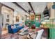 Inviting living room featuring wood beams, green wainscoting, and colorful rug at 54 Gibbes St, Charleston, SC 29401