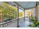 Picturesque porch with blue ceiling, white columns, and a view of the tree-lined street at 54 Gibbes St, Charleston, SC 29401