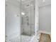 Modern bathroom with glass shower, white tiles, and patterned floor, offering a sleek and clean design at 54 Gibbes St, Charleston, SC 29401
