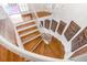 A winding staircase with wooden steps and a white railing, complemented by decorative wooden panels on the wall at 54 Gibbes St, Charleston, SC 29401