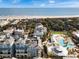 Aerial view of resort, pool, and ocean-front property in beautiful community at 5802 Palmetto Dr # B-202, Isle of Palms, SC 29451