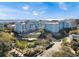 Beautiful resort with light blue buildings, lush landscaping, and a serene pond at 5802 Palmetto Dr # B-202, Isle of Palms, SC 29451