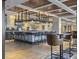 An inviting bar area with a striking overhead glass rack display, dark barstools, and nearby table seating at 5802 Palmetto Dr # B-202, Isle of Palms, SC 29451