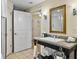 Bathroom showcasing a single vanity with granite countertop, framed mirror, and linen storage for a functional and luxurious feel at 5802 Palmetto Dr # B-202, Isle of Palms, SC 29451