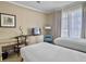 Charming bedroom with two twin beds, a writing desk, and natural light at 5802 Palmetto Dr # B-202, Isle of Palms, SC 29451