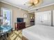 Bright bedroom with a cozy chair, television, and access to outdoor balcony at 5802 Palmetto Dr # B-202, Isle of Palms, SC 29451