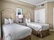 Relaxing bedroom featuring two beds, soft colors, and an ensuite bathroom at 5802 Palmetto Dr # B-202, Isle of Palms, SC 29451